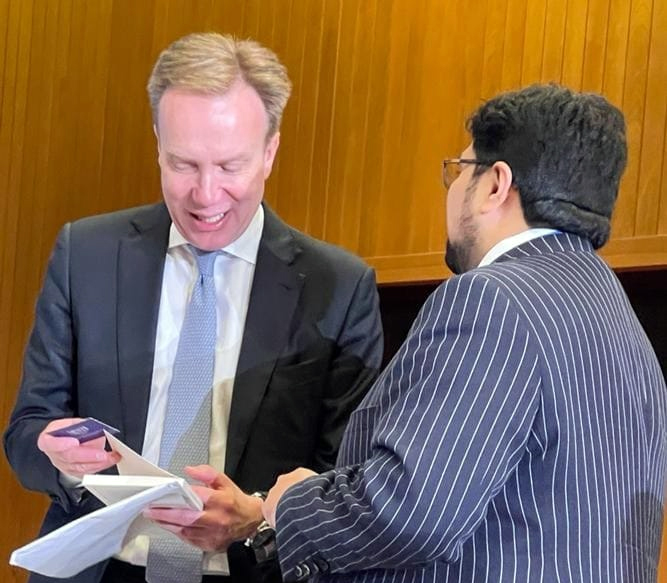Dr Hussain Mohi ud Din Qadri is presenting book to World Economic Forum President Borge Brende