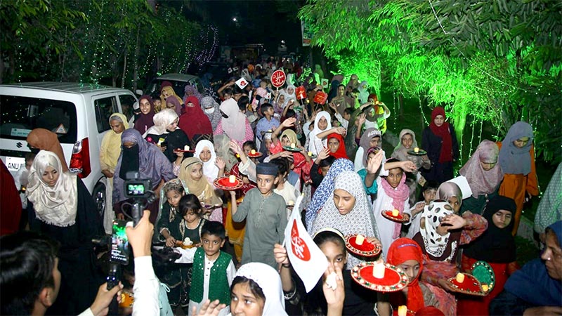 Children participate in a candle walk to welcome Rabi-ul-Awwal